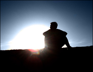 Photo of a man sitting and thinking.